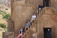 Happy tourists on the cantilevered stairs of Surb Astvatsatsin